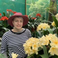 Kyla between the large yellow clivias